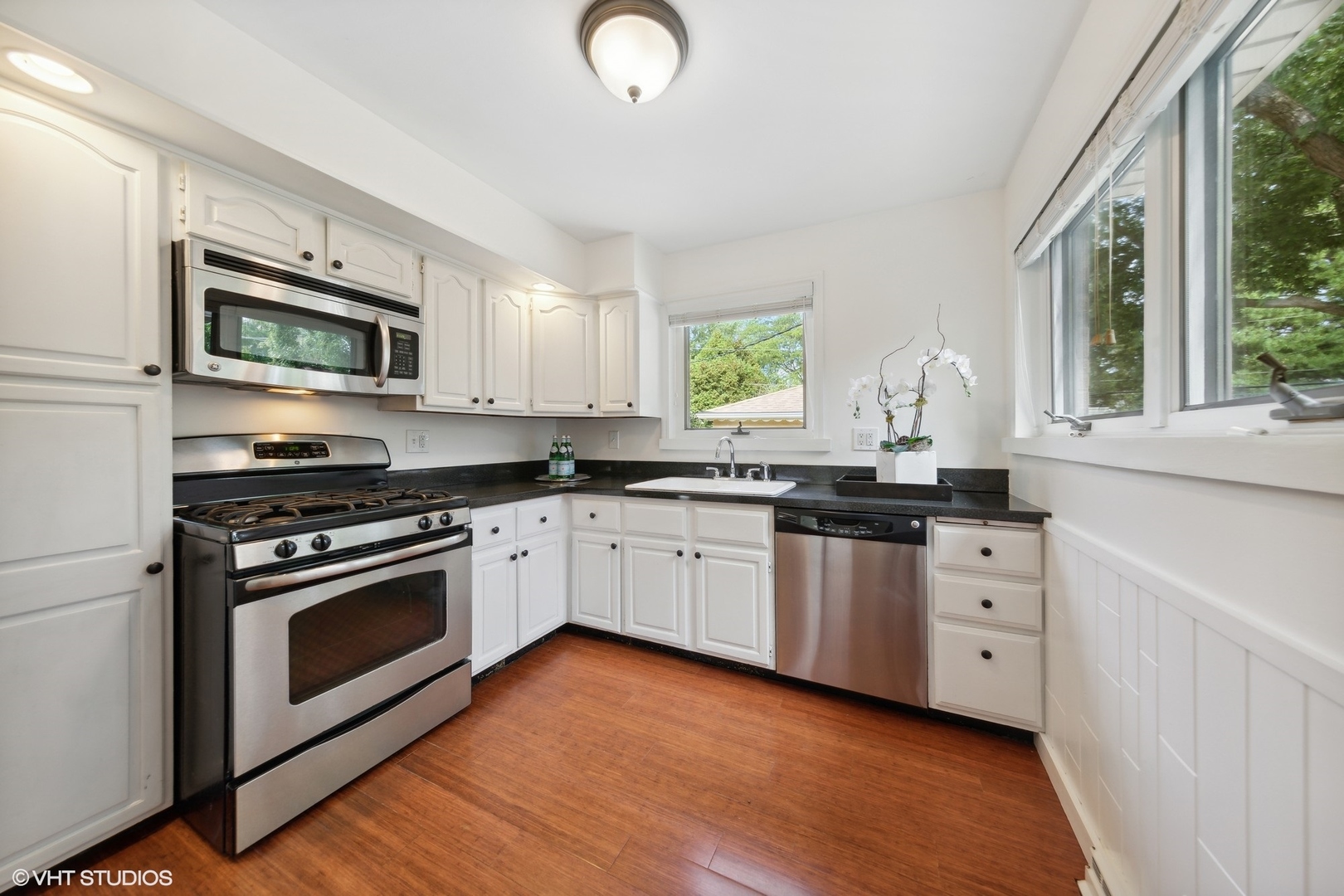 186 West Burlington Street Riverside, IL 60546 - Photo 6 of 19 a kitchen with stainless steel appliances granite countertop a stove a sink and a microwave