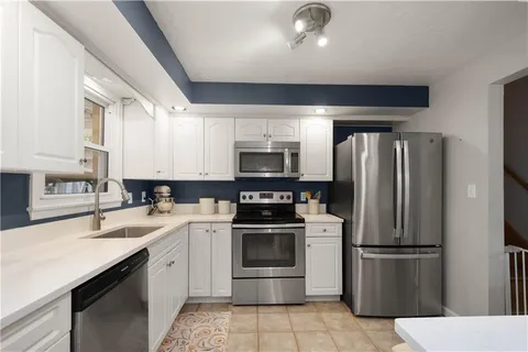 a kitchen with a sink appliances and cabinets