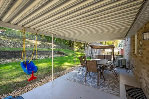 a view of a house with a yard patio and furniture