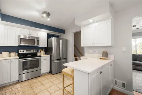 a kitchen with a sink stainless steel appliances and cabinets