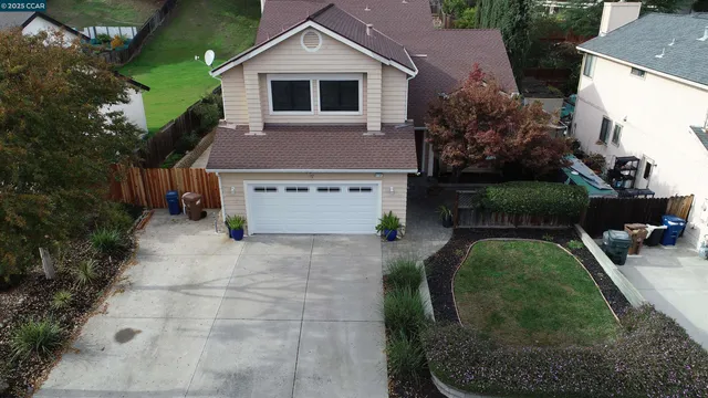 a aerial view of a house with a yard and garage