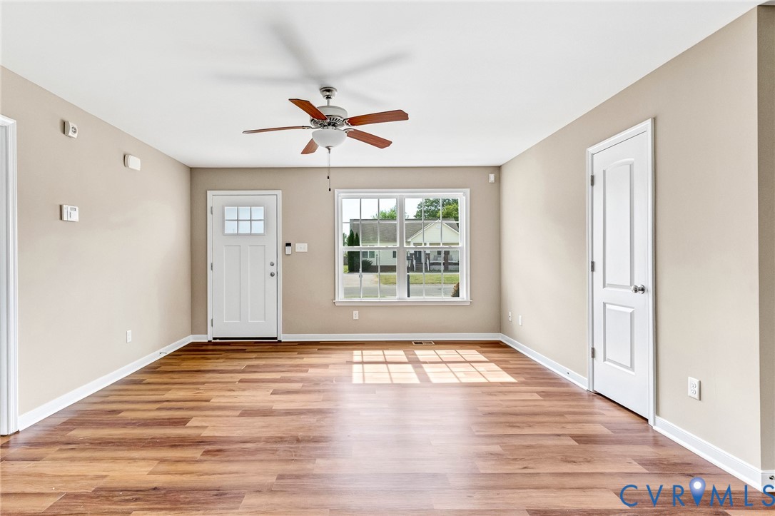 9925 Reymet Court Richmond, VA 23237 - Photo 6 of 30 a view of an empty room with wooden floor and a window