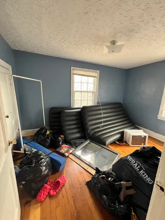 a bedroom with bunk bed and a window