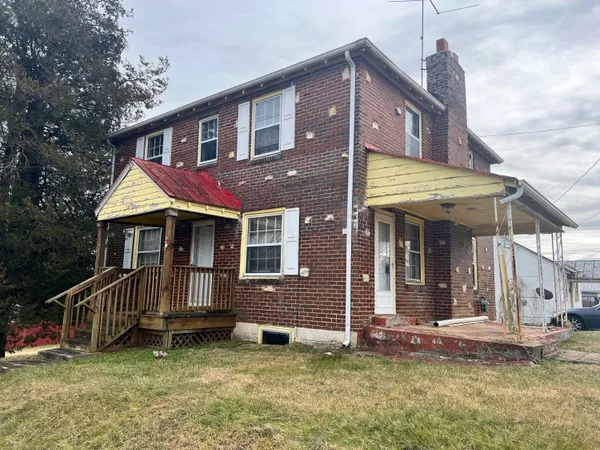 a view of a house with a yard porch and wooden floor