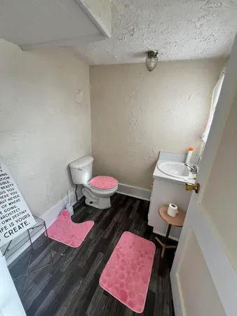 a bathroom with a sink mirror and toilet