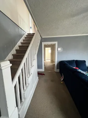 a view of entryway and hall with wooden floor