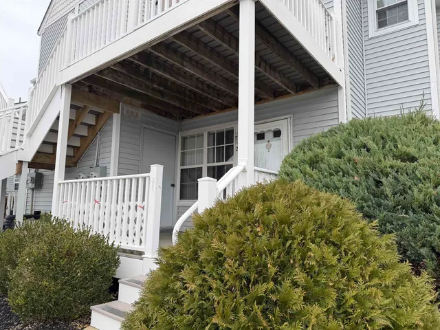 a view of a house with a small yard