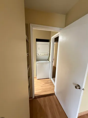 a view of a room with wooden floor and a bathroom