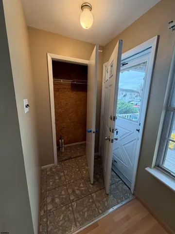 hallway with wooden floor and door