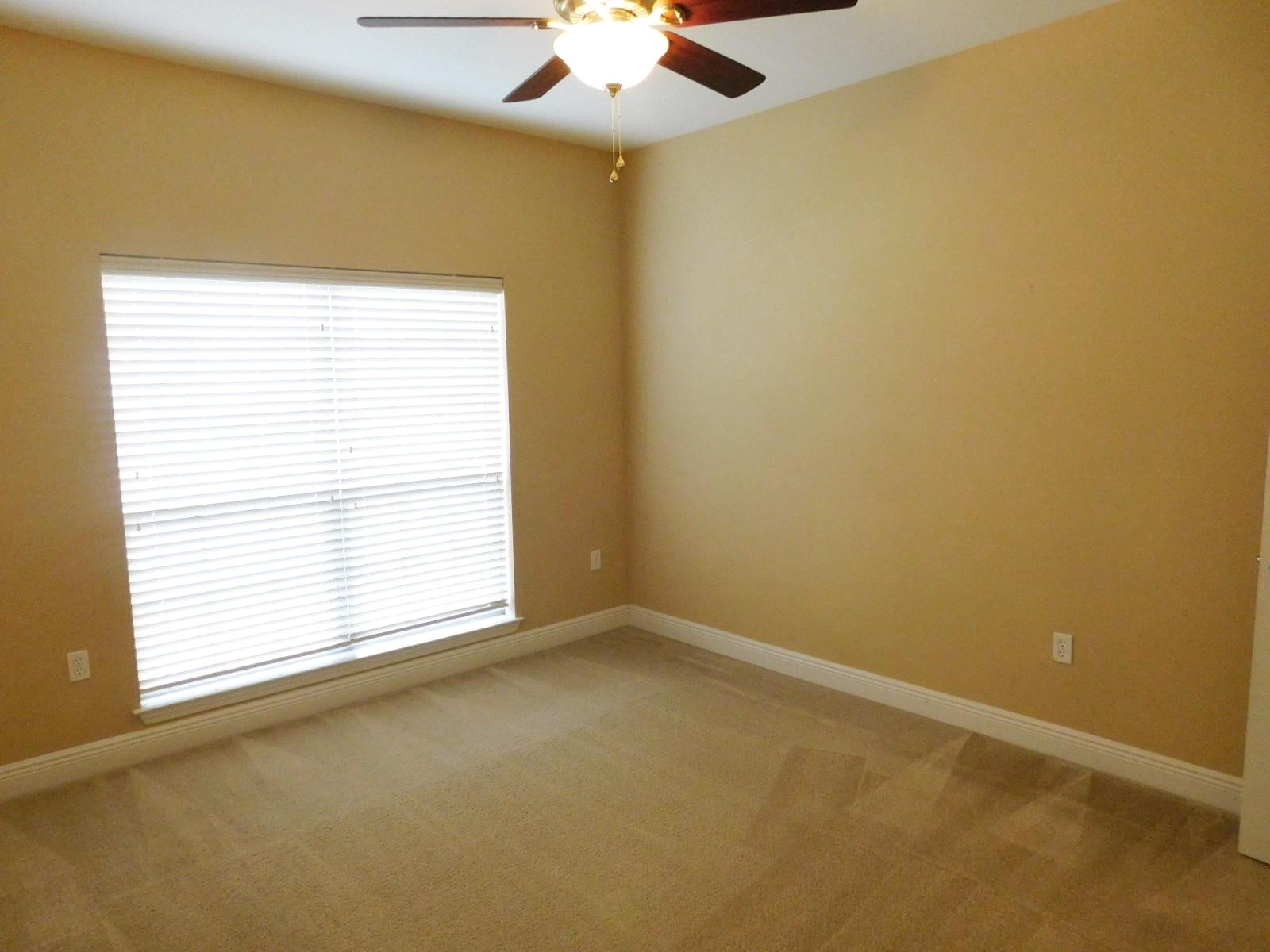 721 Lime Lane Crestview, FL 32536 - Photo 14 of 27 an empty room with a window and a ceiling fan