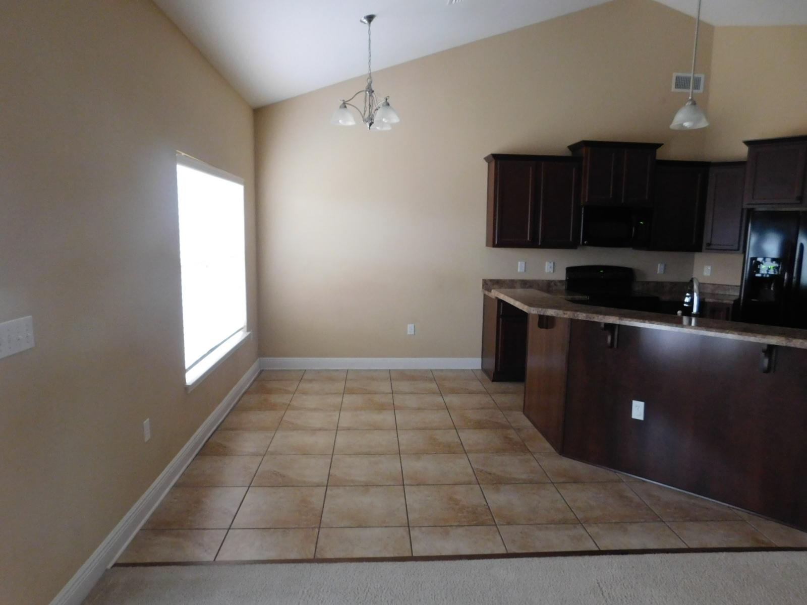721 Lime Lane Crestview, FL 32536 - Photo 16 of 27 a kitchen with stainless steel appliances granite countertop a stove a sink and a microwave