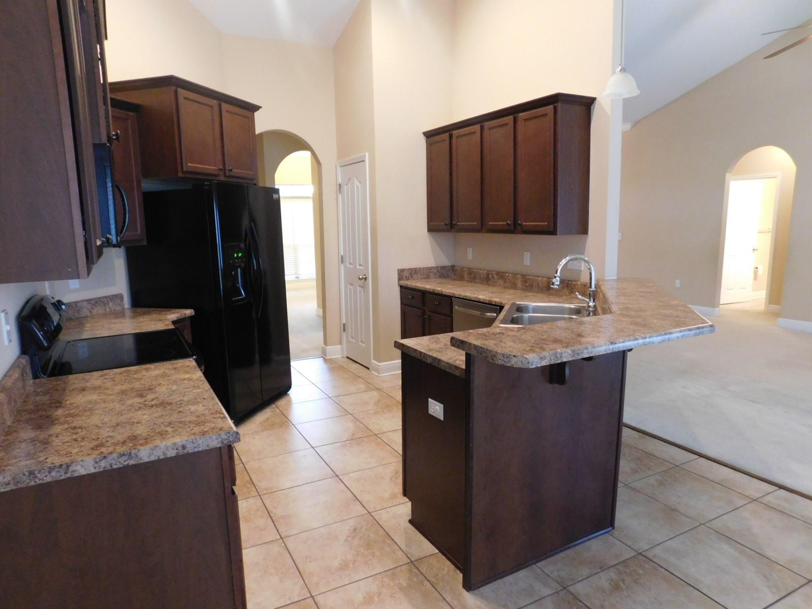 721 Lime Lane Crestview, FL 32536 - Photo 17 of 27 a kitchen with a sink stove and refrigerator