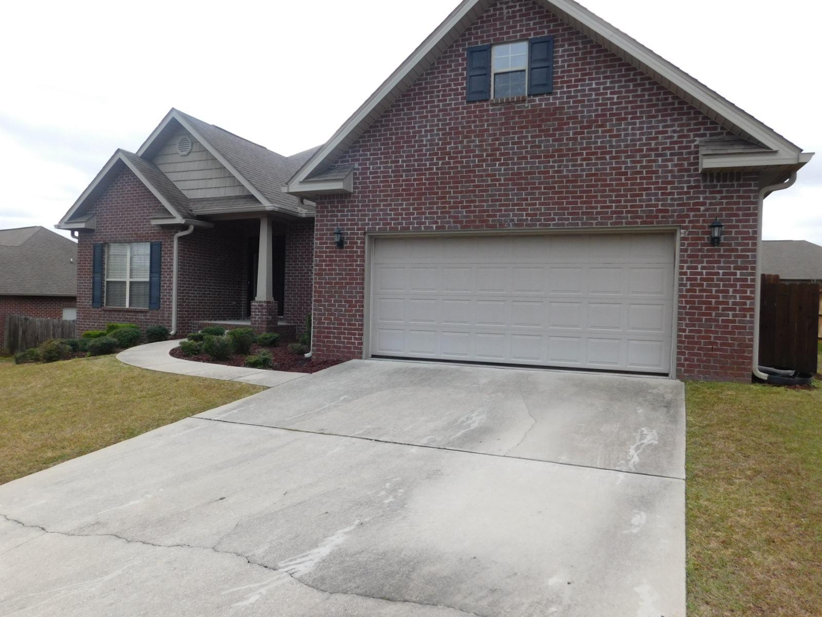 721 Lime Lane Crestview, FL 32536 - Photo 2 of 27 a front view of a house with a yard and garage