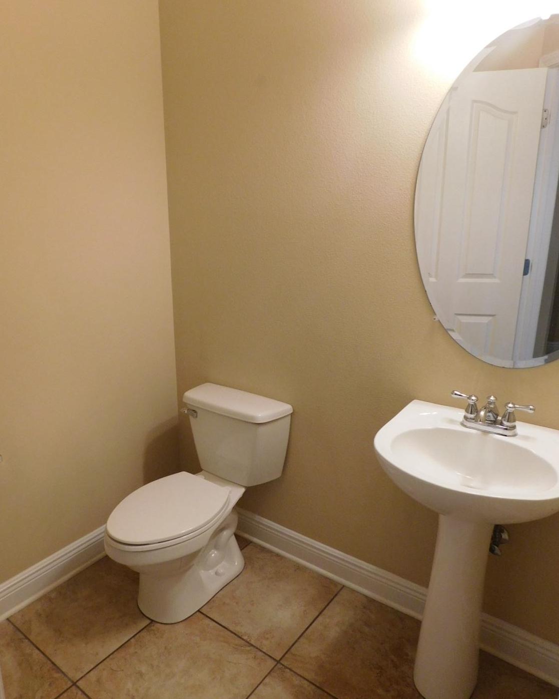 721 Lime Lane Crestview, FL 32536 - Photo 22 of 27 a bathroom with a toilet a sink and mirror
