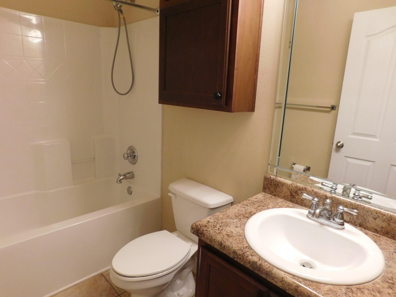 721 Lime Lane Crestview, FL 32536 - Photo 23 of 27 a bathroom with a granite countertop sink toilet a mirror and shower
