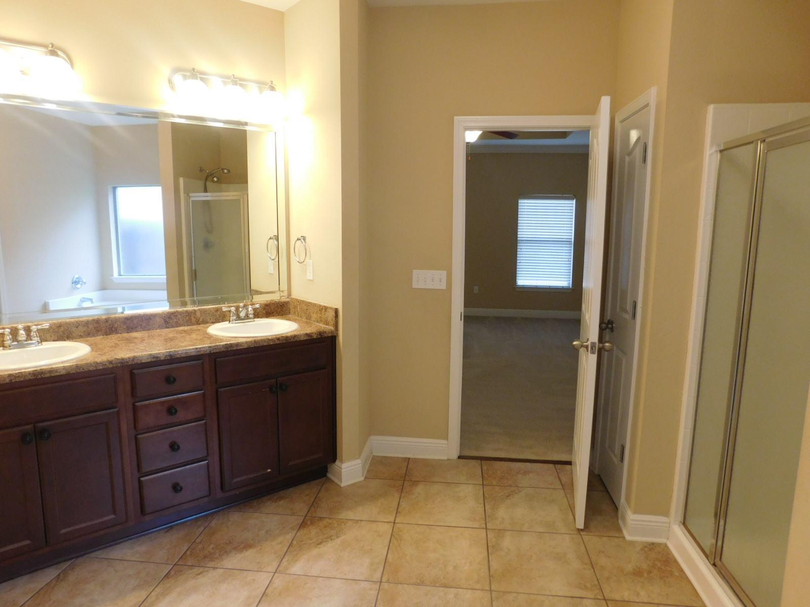 721 Lime Lane Crestview, FL 32536 - Photo 25 of 27 a bathroom with a granite countertop sink and a mirror