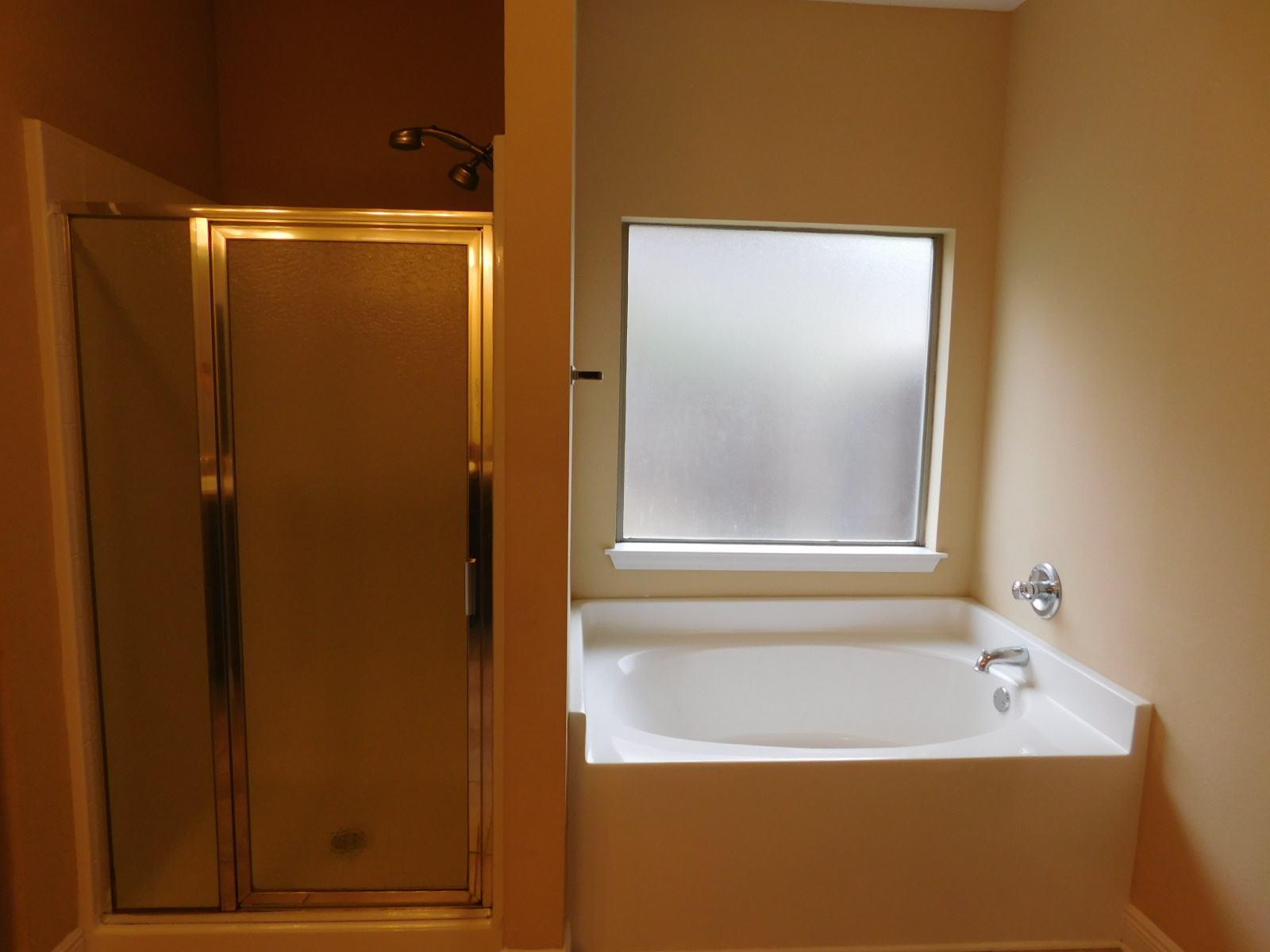 721 Lime Lane Crestview, FL 32536 - Photo 26 of 27 a bathroom with a bathtub and a shower