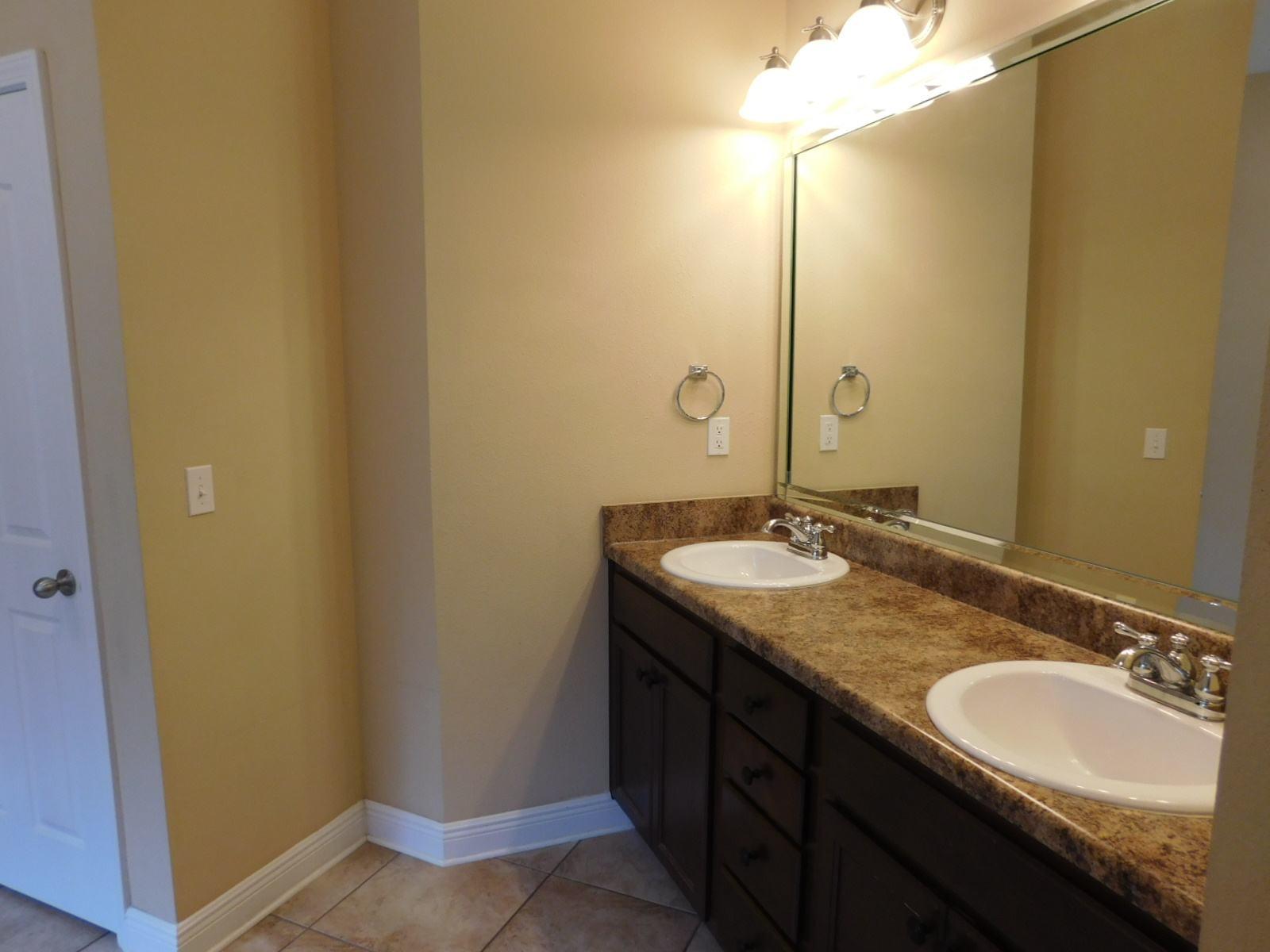 721 Lime Lane Crestview, FL 32536 - Photo 27 of 27 a bathroom with a granite countertop sink and a mirror