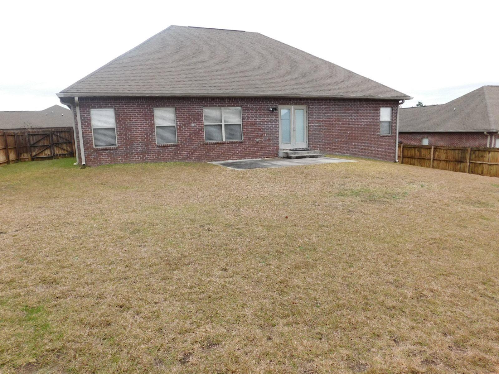 721 Lime Lane Crestview, FL 32536 - Photo 5 of 27 a front view of a house with a yard