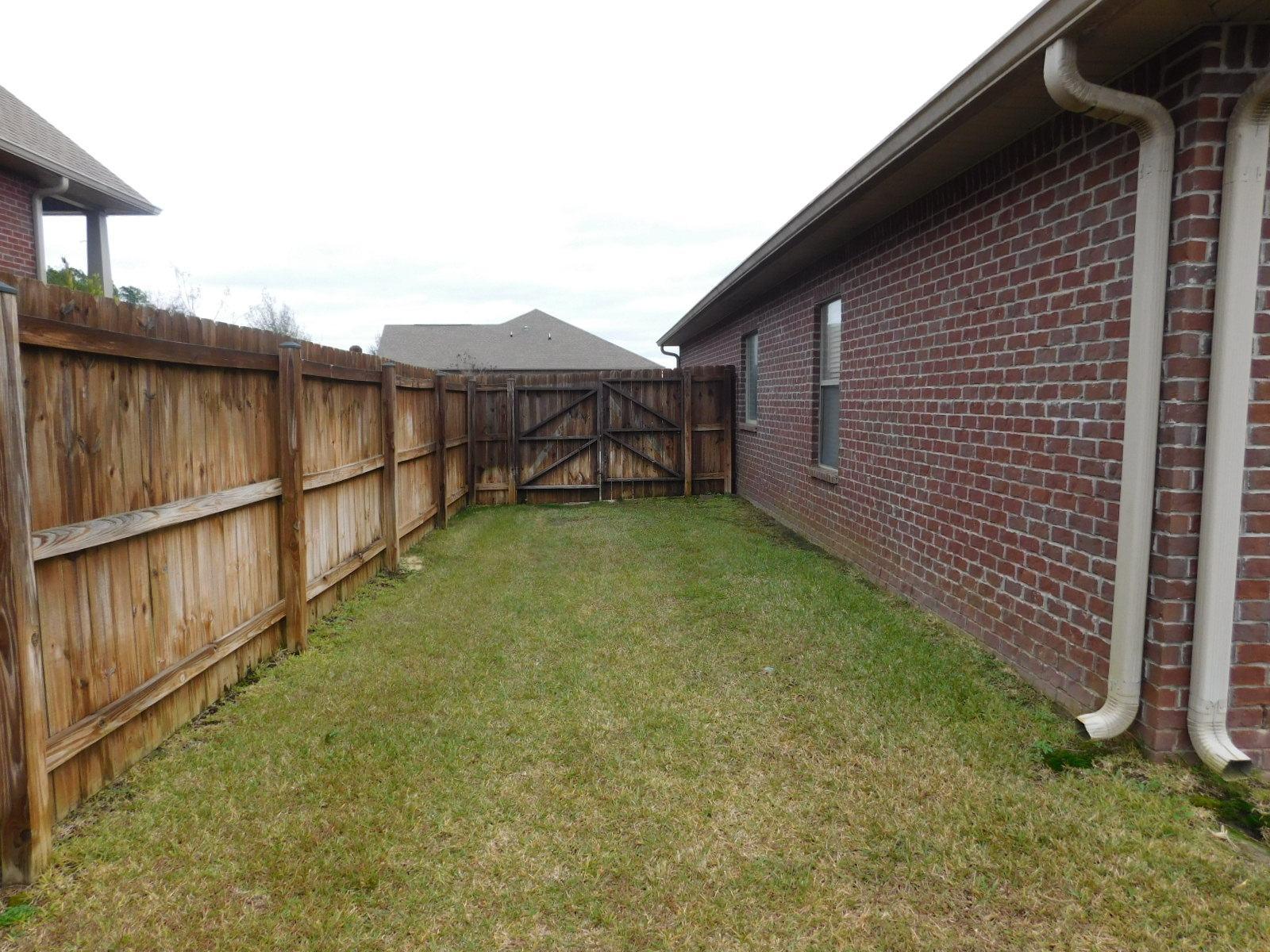 721 Lime Lane Crestview, FL 32536 - Photo 6 of 27 a view of a backyard with a garden