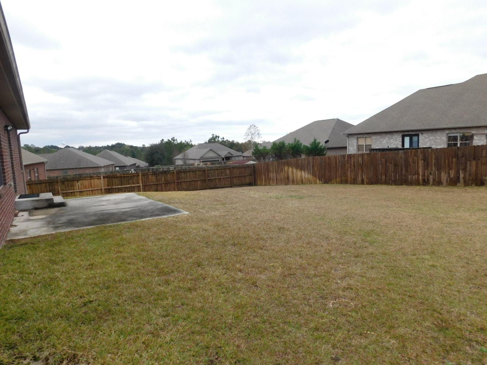 721 Lime Lane Crestview, FL 32536 - Photo 8 of 27 a view of a lake with a yard