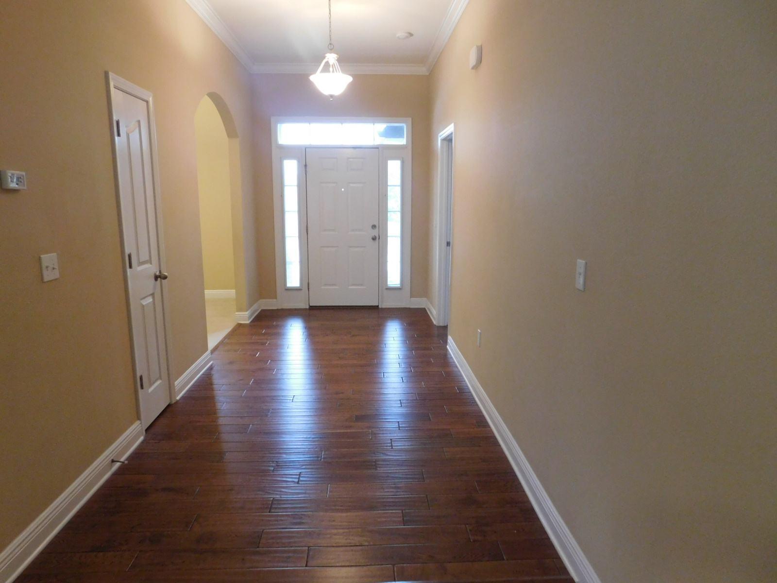 721 Lime Lane Crestview, FL 32536 - Photo 9 of 27 a view of a hallway with wooden floor