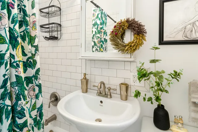 a bathroom sink with a potted plant