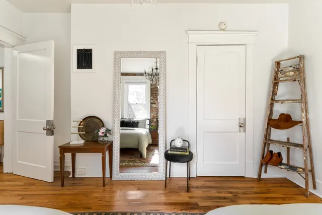 a kitchen with a stove and a white wooden cabinets