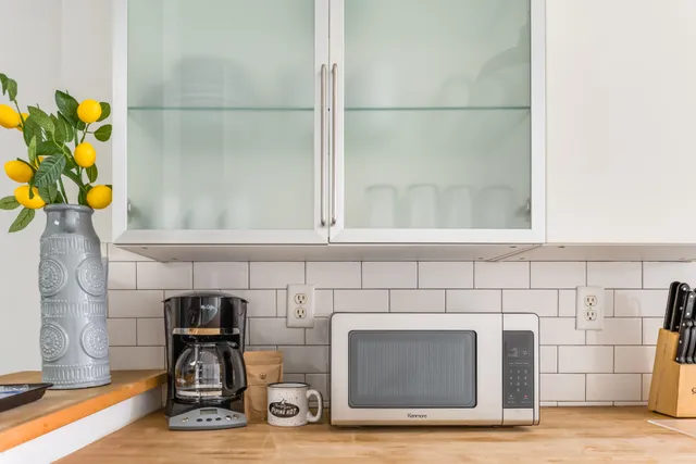 a kitchen with kitchen island a sink and a stove