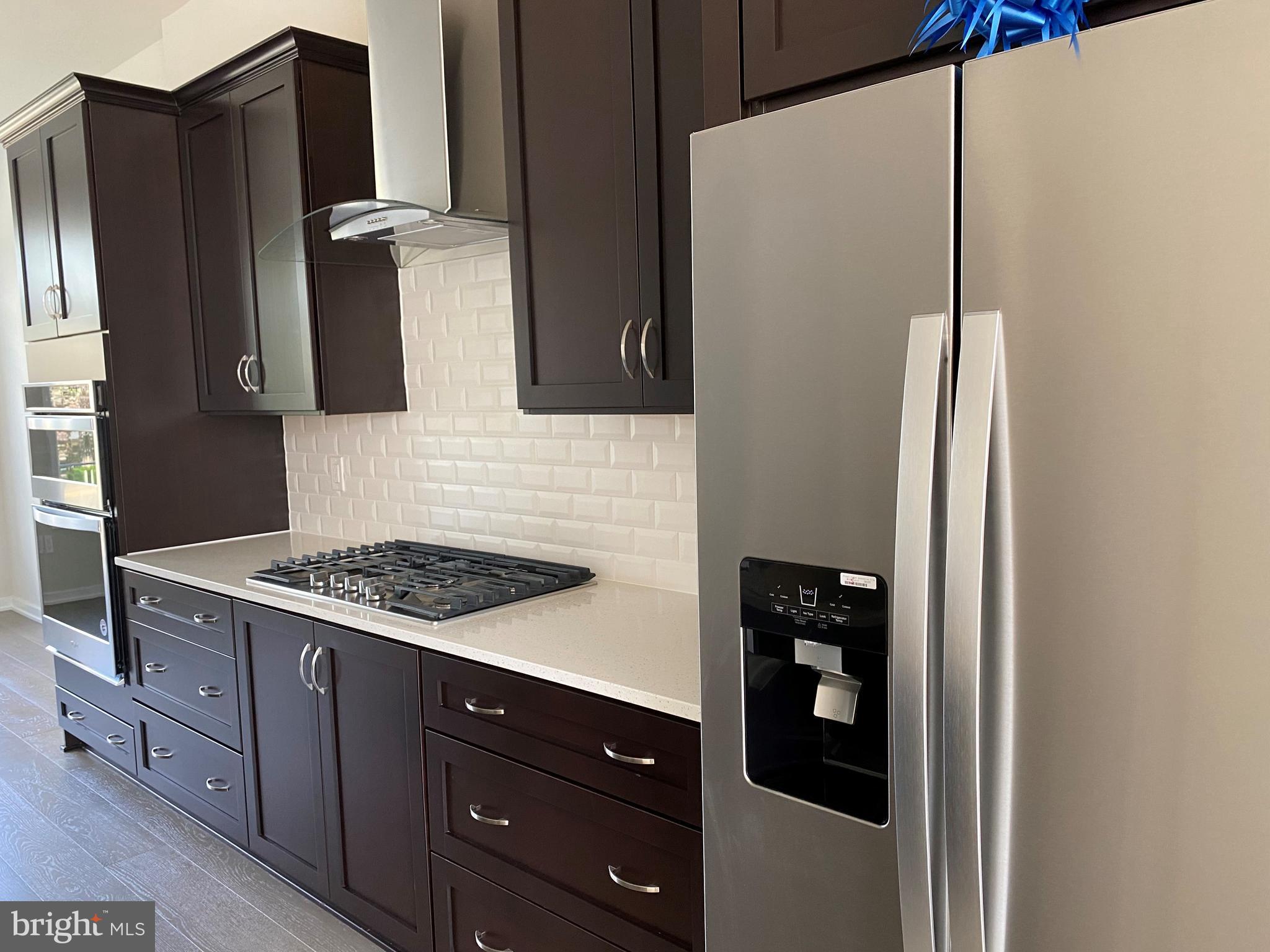 1708 Anderson Road McLean, VA 22102 - Photo 3 of 13 a kitchen with stainless steel appliances granite countertop a refrigerator and a stove