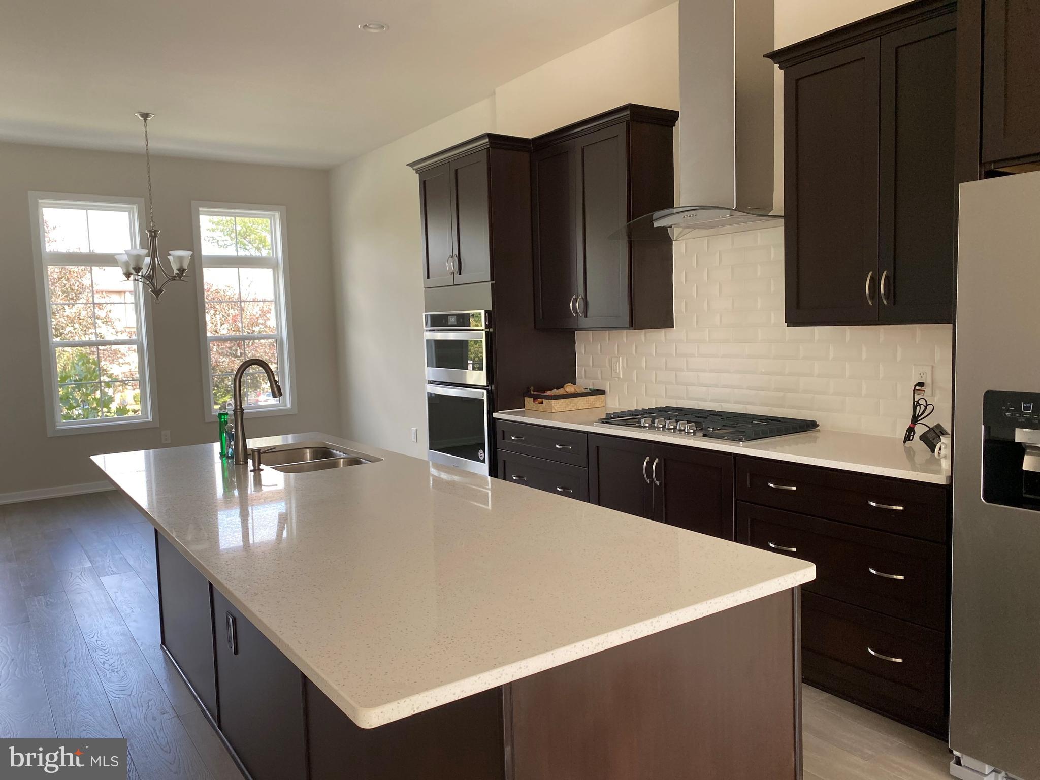 1708 Anderson Road McLean, VA 22102 - Photo 4 of 13 a large kitchen with sink a refrigerator and wooden cabinets