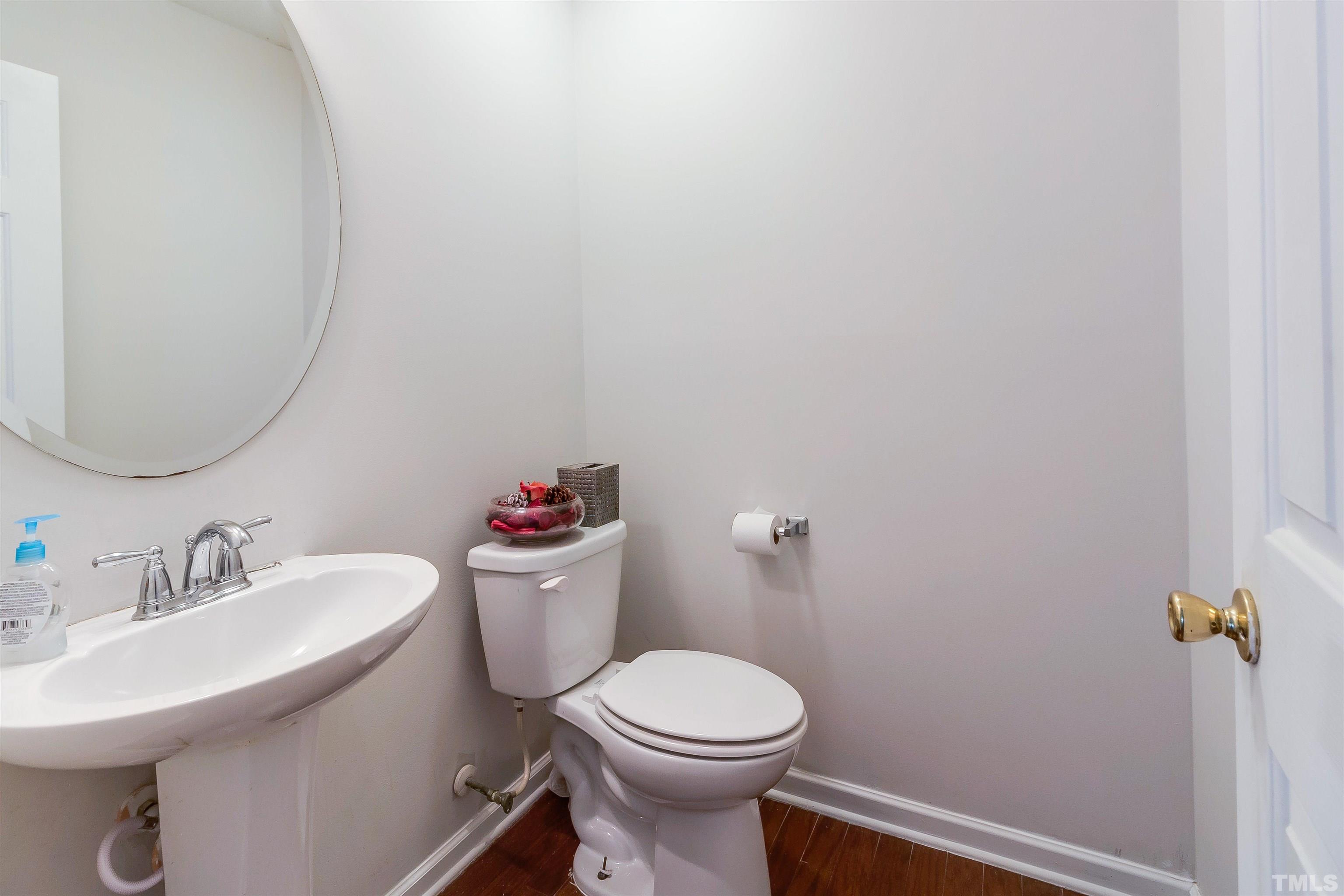 3305 Perkins Ridge Road Raleigh, NC 27610 - Photo 13 of 22 a white toilet sitting next to a bathroom sink