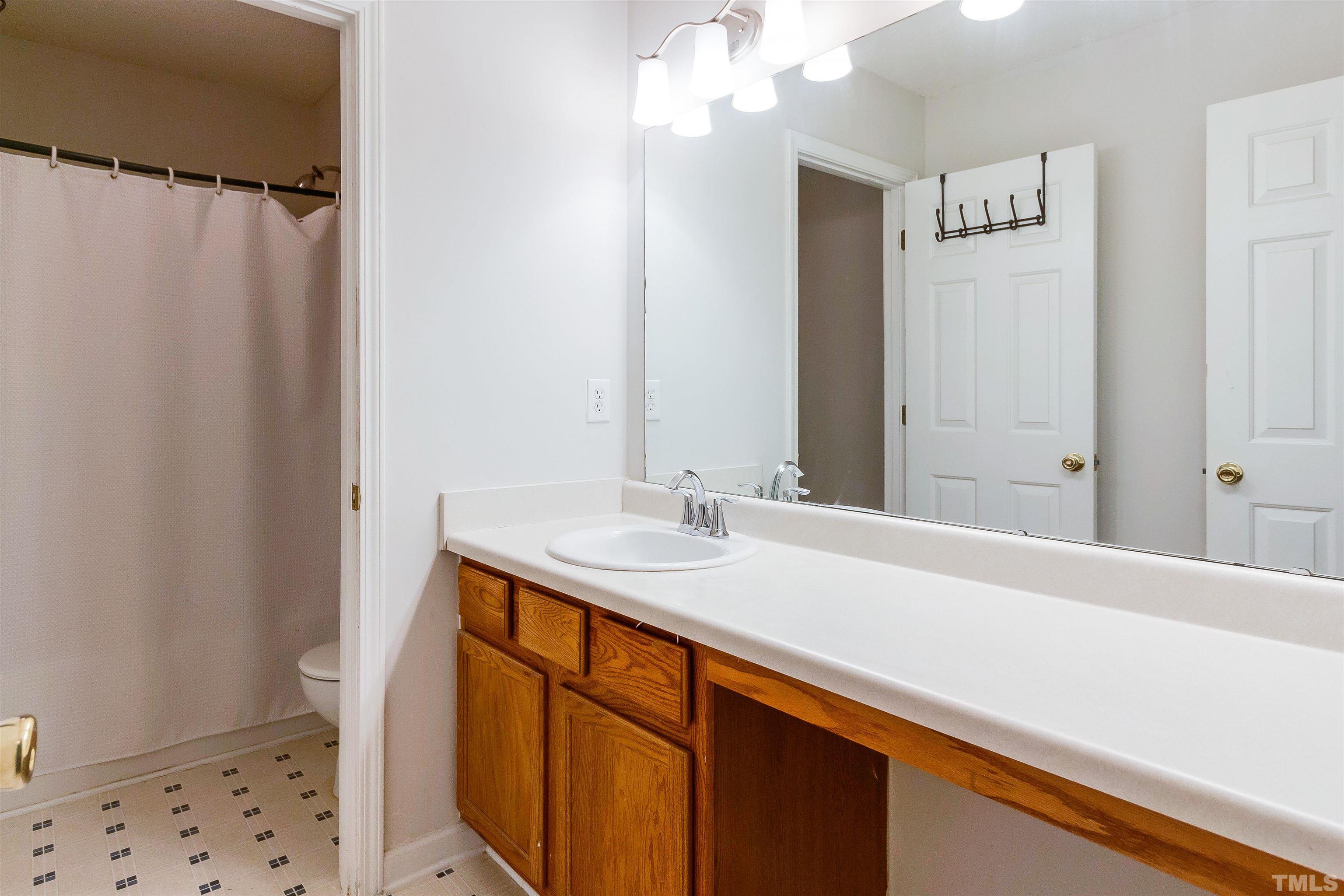 3305 Perkins Ridge Road Raleigh, NC 27610 - Photo 16 of 22 a bathroom with a sink and a mirror