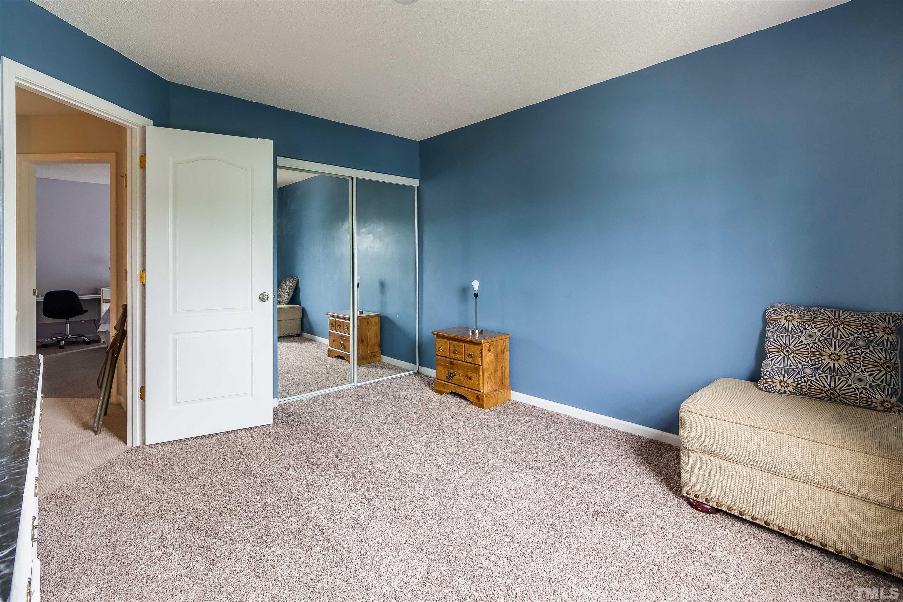 3305 Perkins Ridge Road Raleigh, NC 27610 - Photo 17 of 22 a bedroom with a bed and a couch