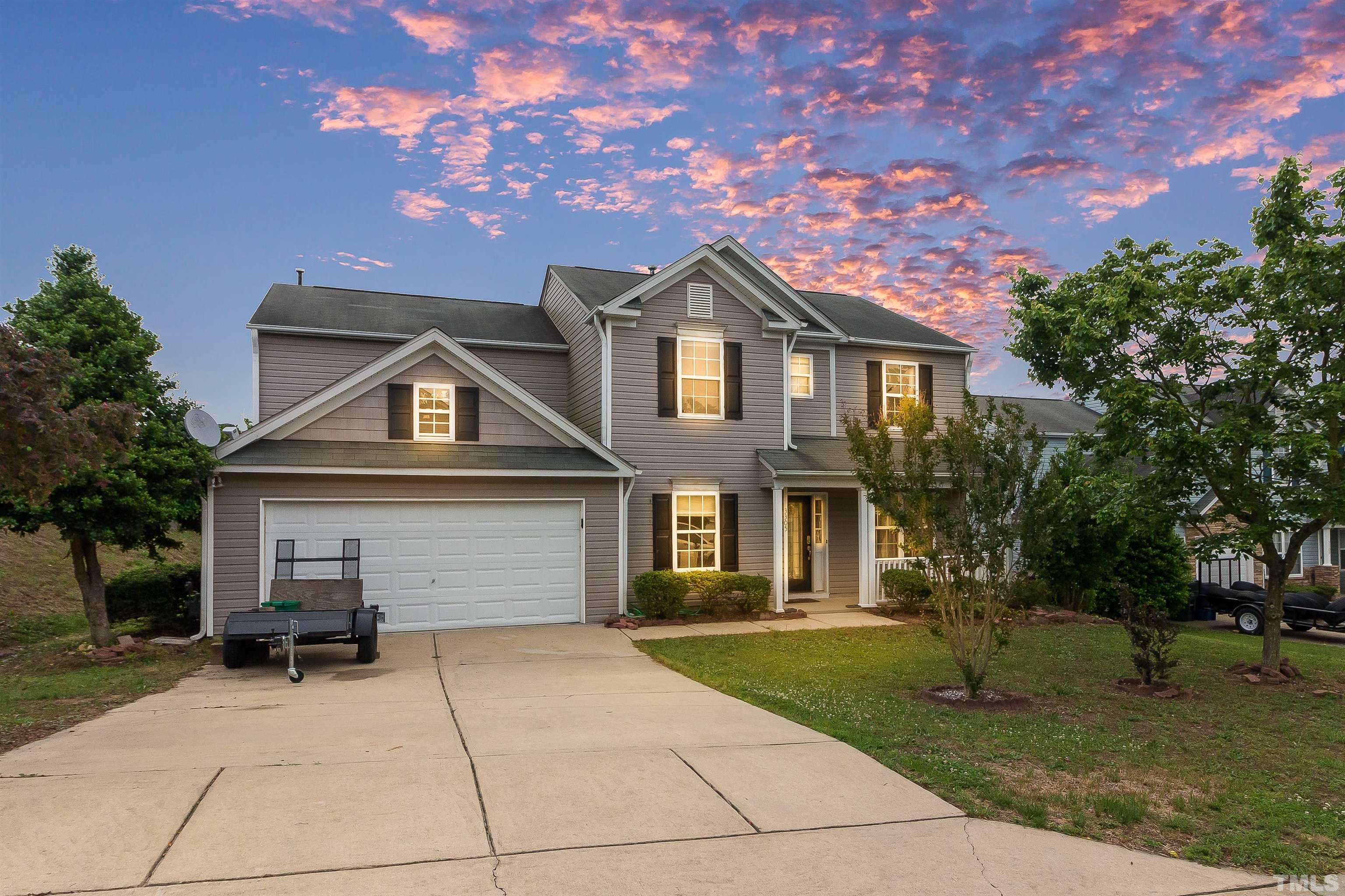 3305 Perkins Ridge Road Raleigh, NC 27610 - Photo 2 of 22 a front view of a house with a yard and trees