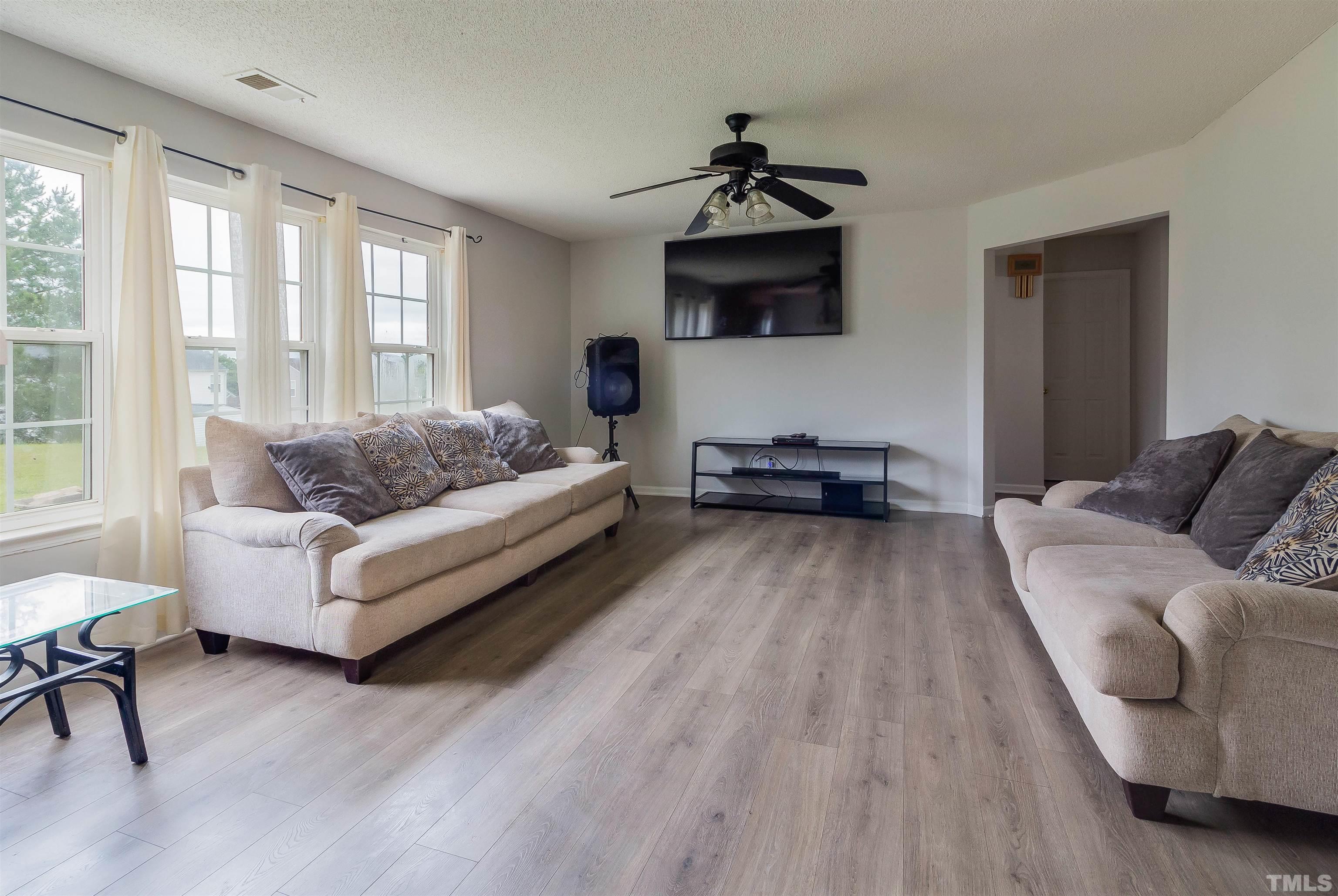 3305 Perkins Ridge Road Raleigh, NC 27610 - Photo 4 of 22 a living room with furniture and a flat screen tv