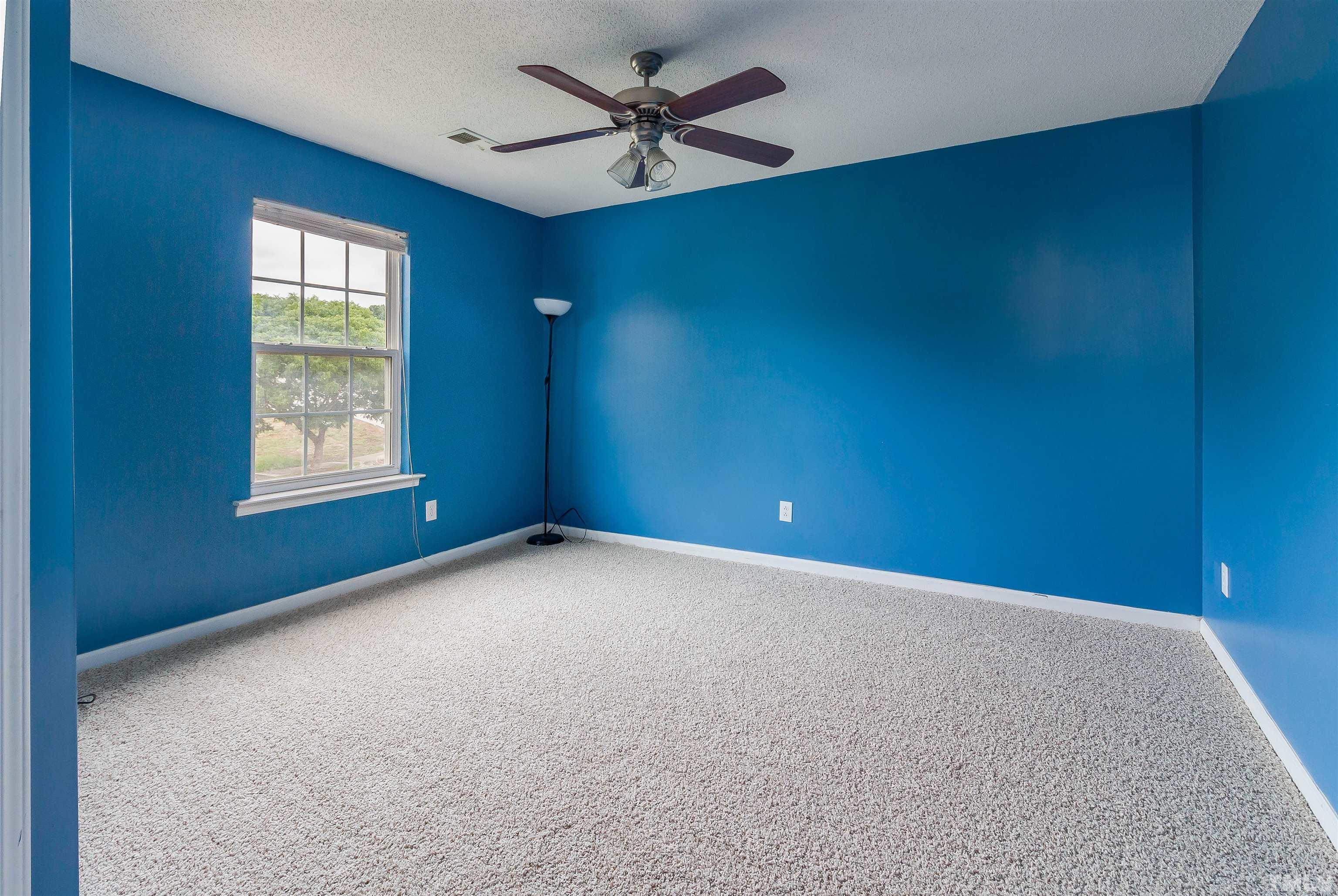3305 Perkins Ridge Road Raleigh, NC 27610 - Photo 8 of 22 an empty room with windows and fan