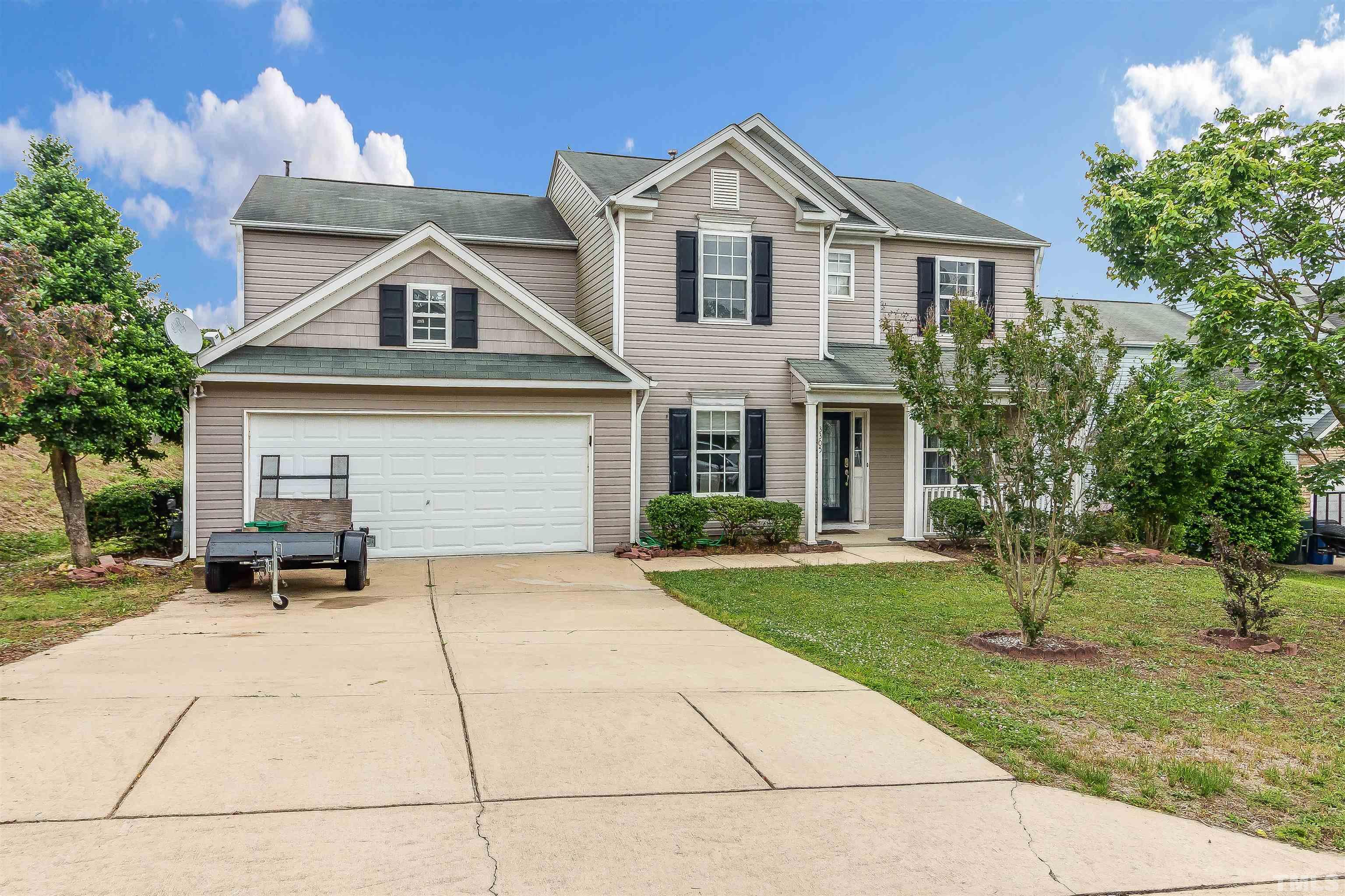 3305 Perkins Ridge Road Raleigh, NC 27610 - Photo 9 of 22 a front view of a house with a yard