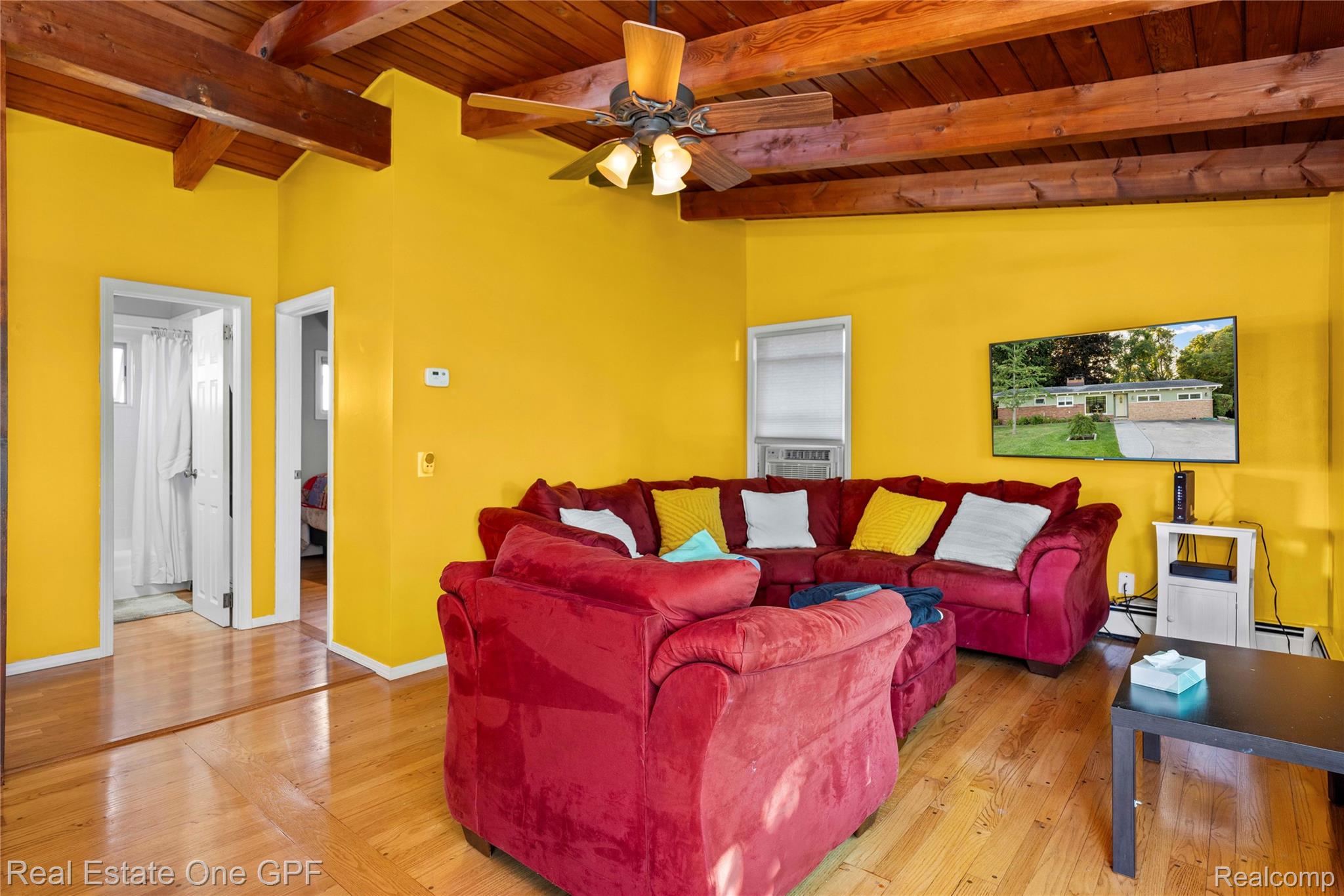 5068 Atkins Road North Street, MI 48049 - Photo 24 of 78 Wood-finish flooring, exposed wood beam ceiling, ceiling fan with integrated lighting, and white interior doors