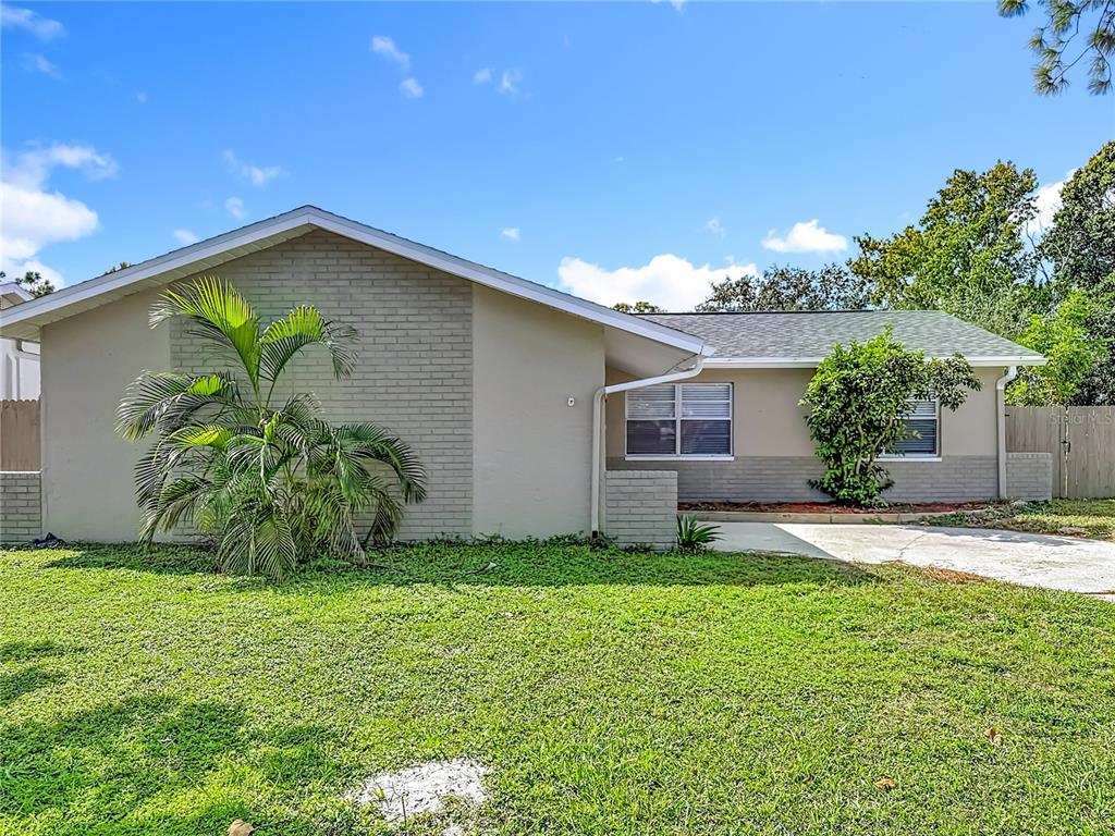 7480 118th Terrace Largo, FL 33773 - Photo 12 of 49 a front view of a house with a yard and garage
