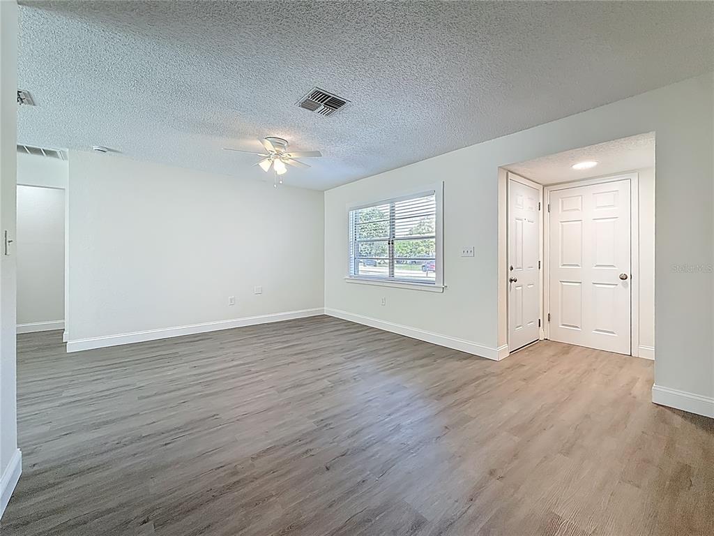 7480 118th Terrace Largo, FL 33773 - Photo 16 of 49 an empty room with wooden floor and windows