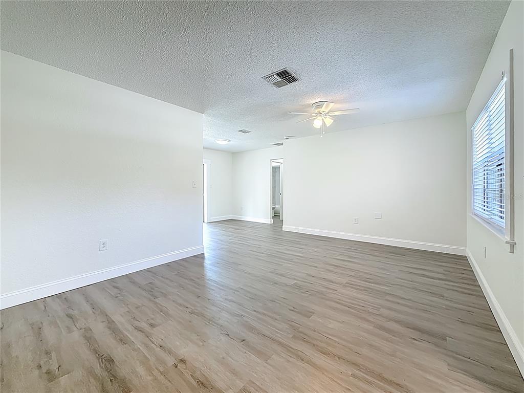 7480 118th Terrace Largo, FL 33773 - Photo 18 of 49 wooden floor in an empty room with a window