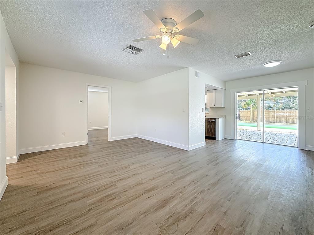 7480 118th Terrace Largo, FL 33773 - Photo 19 of 49 a view of an empty room with a window and wooden floor
