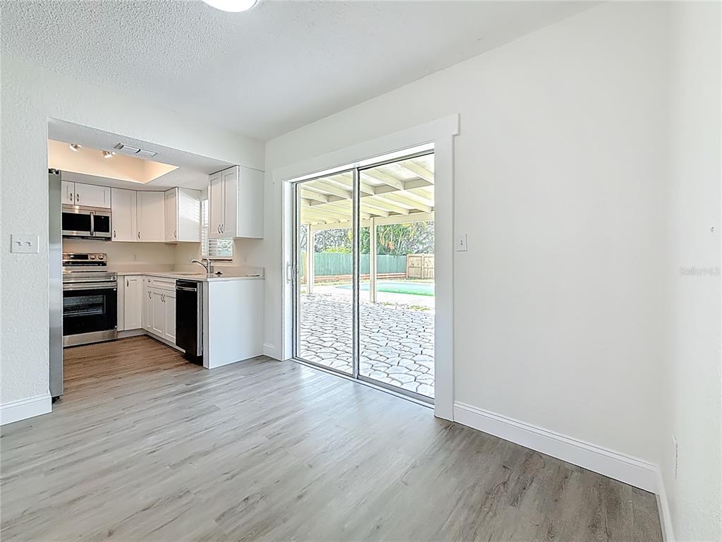 7480 118th Terrace Largo, FL 33773 - Photo 20 of 49 a view of a kitchen with wooden floor and electronic appliances