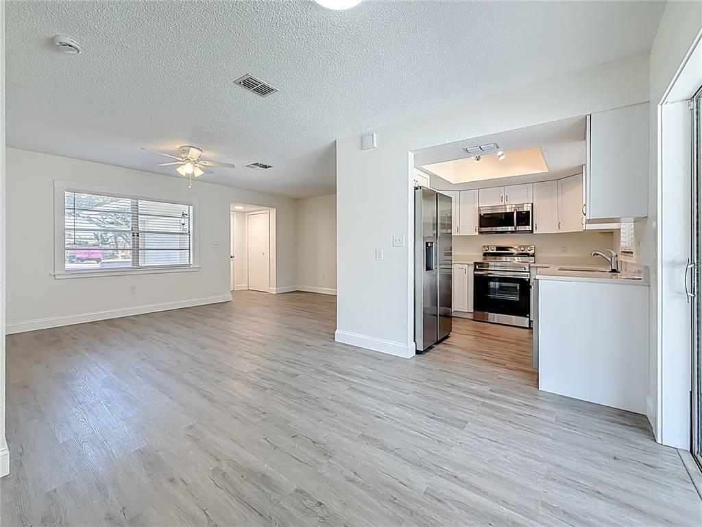 7480 118th Terrace Largo, FL 33773 - Photo 21 of 49 a view of a kitchen with a sink stove cabinets and empty room