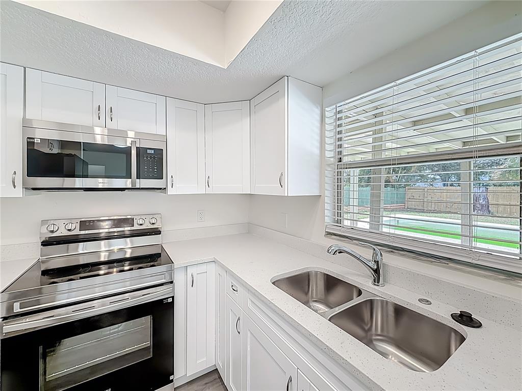 7480 118th Terrace Largo, FL 33773 - Photo 25 of 49 a kitchen with a sink and stainless steel appliances
