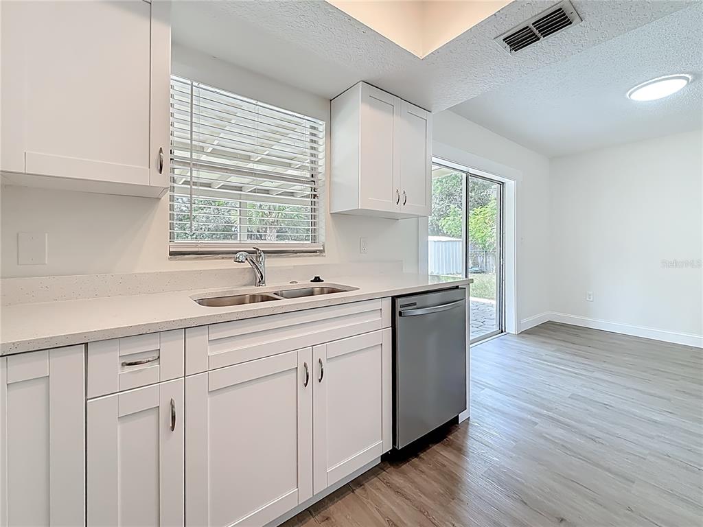 7480 118th Terrace Largo, FL 33773 - Photo 26 of 49 a kitchen with sink cabinets and wooden floor