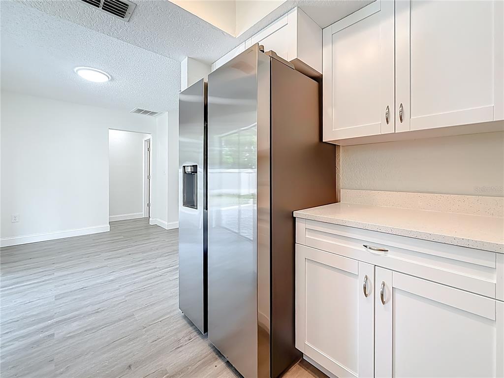 7480 118th Terrace Largo, FL 33773 - Photo 27 of 49 a kitchen with stainless steel appliances a refrigerator and cabinets
