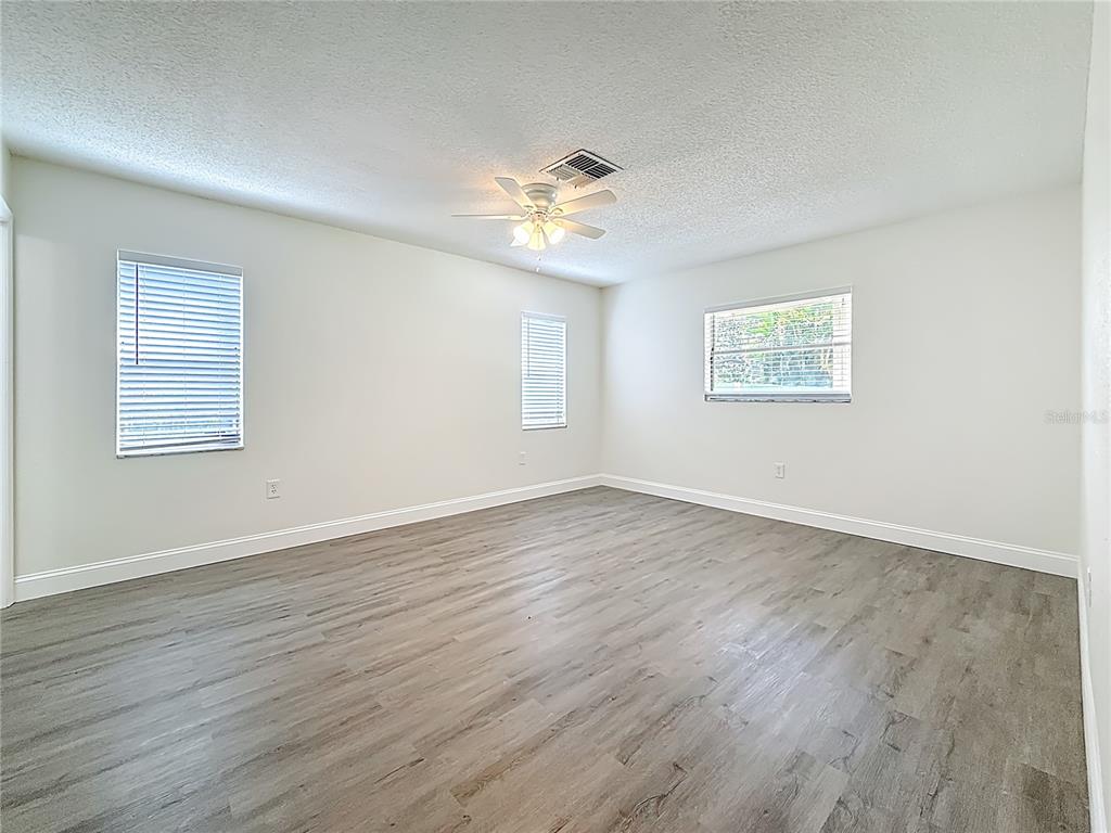 7480 118th Terrace Largo, FL 33773 - Photo 28 of 49 a view of an empty room with wooden floor and a window
