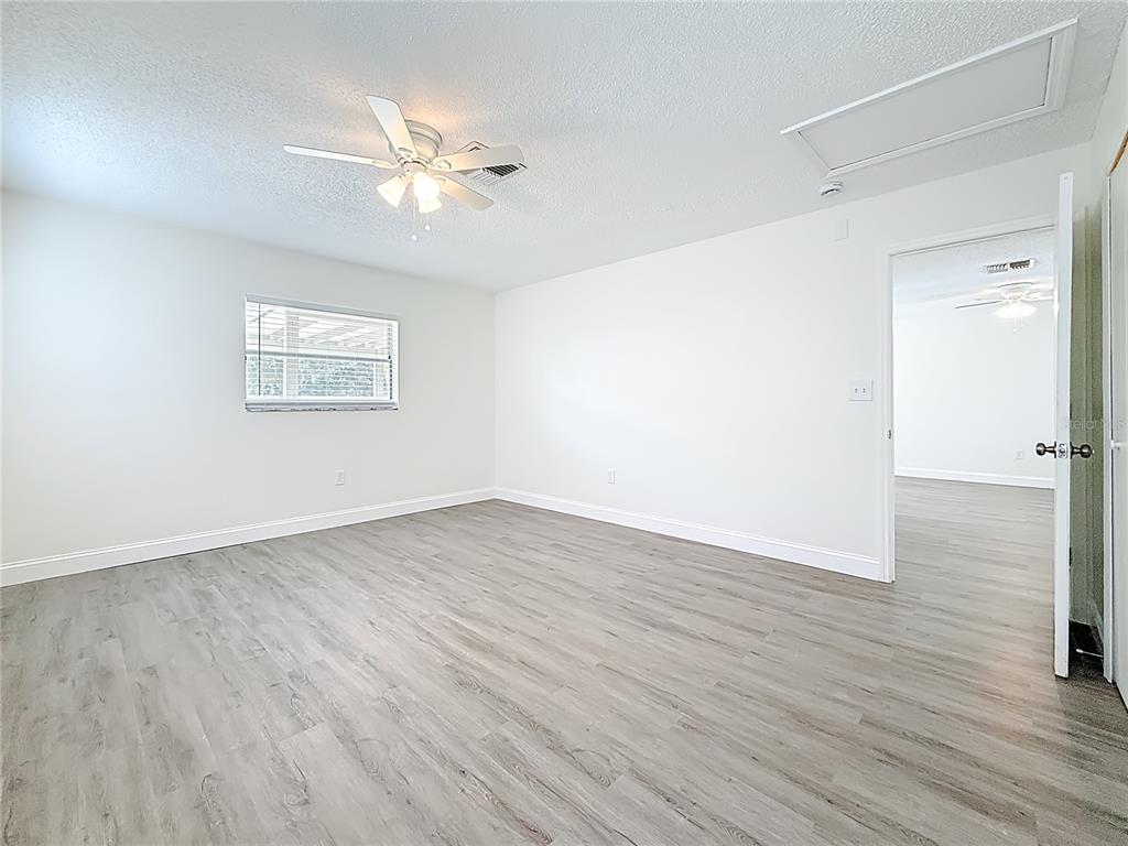 7480 118th Terrace Largo, FL 33773 - Photo 29 of 49 an empty room with wooden floor a ceiling fan and closet